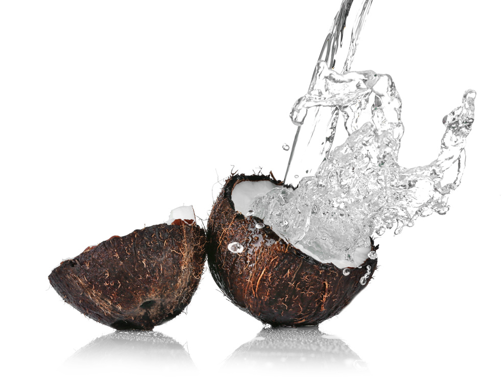 Cracked Coconut with Jet of Water on White Background